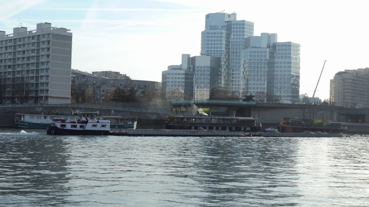 Barge carrying sand on a river in the city center or business district