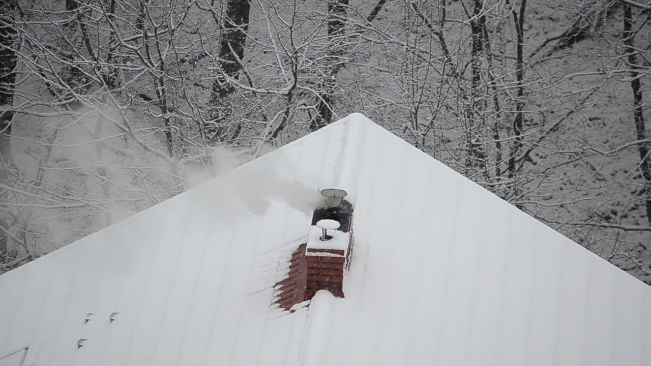 Smoke from the chimney on a snow background