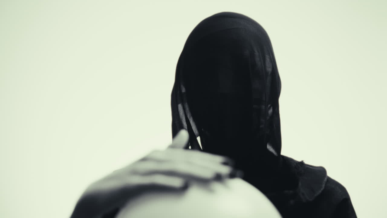 Mysterious Woman in Black Hijab Holding a Sphere