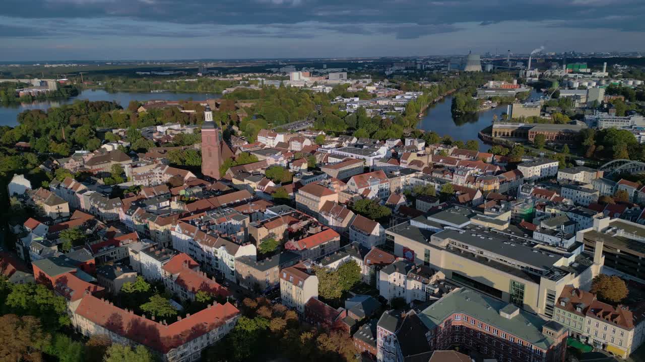 Berlin Spandau old town with its red rooftops, churches, and surrounding greenery. Great aerial view flight wide orbit overview drone