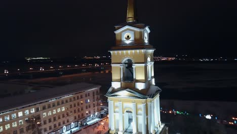 snowy city bell tower at night