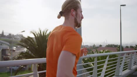 sporty caucasian man training on a bridge