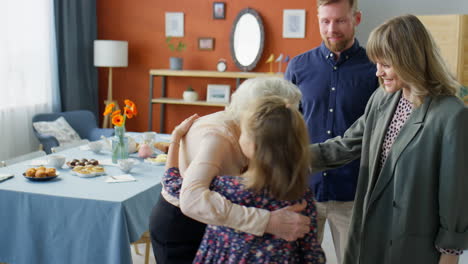 happy grandmother meeting family for holiday dinner at home