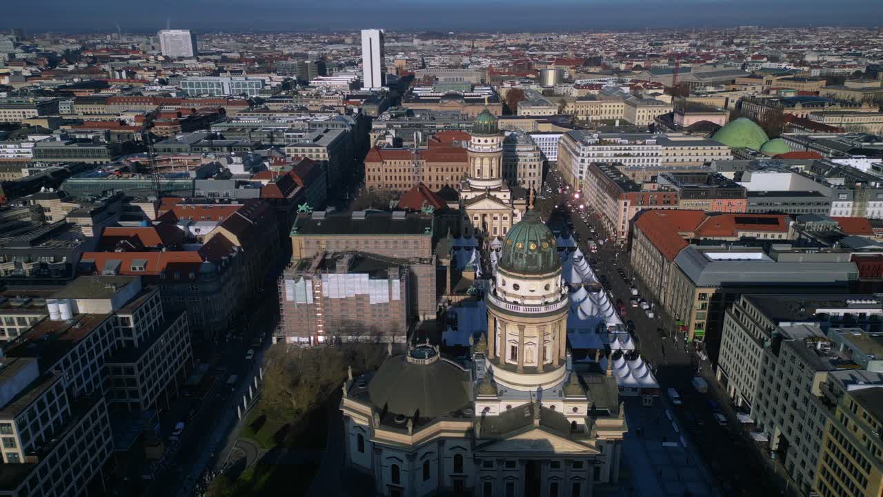 Berlin Gendarmenmarkt square including german Dom and French Dom from an aerial perspective. Majestic aerial view fly reverse drone