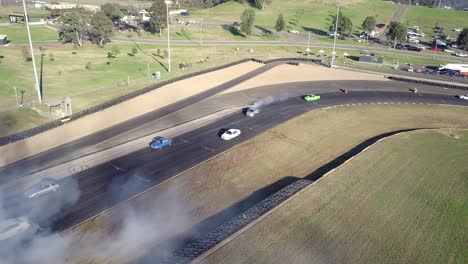 aerial view of cars and smoke pollution at the racing track of sydney motorsport park