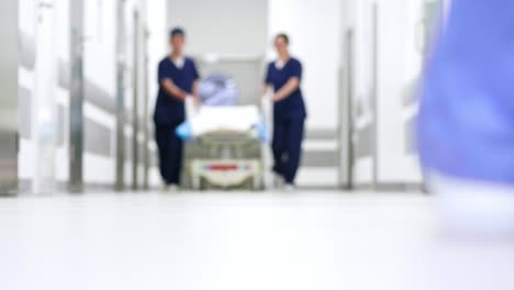 Blurred-view-of-doctors-on-the-corridor-in-hospital