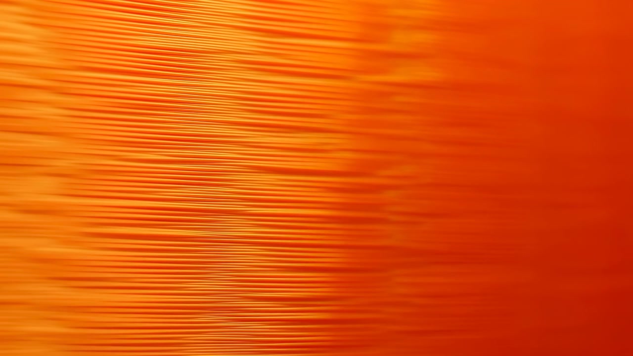 Abstrakta orangea texturer utan observerad rörelse, i en abstrakt bakgrund med orangea mönster och texturer, från ett statiskt perspektiv, med orangea och gula accenter.
