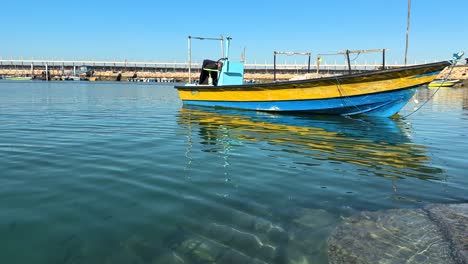 alone-single-boat-float-on-water-sea-side-beach-the-harbor-coastal-landscape-sailor-riding-boat-on-the-sea-fishing-purposes-fisherman-old-ancient-traditional-skill-of-fishing-and-dolphin-watching