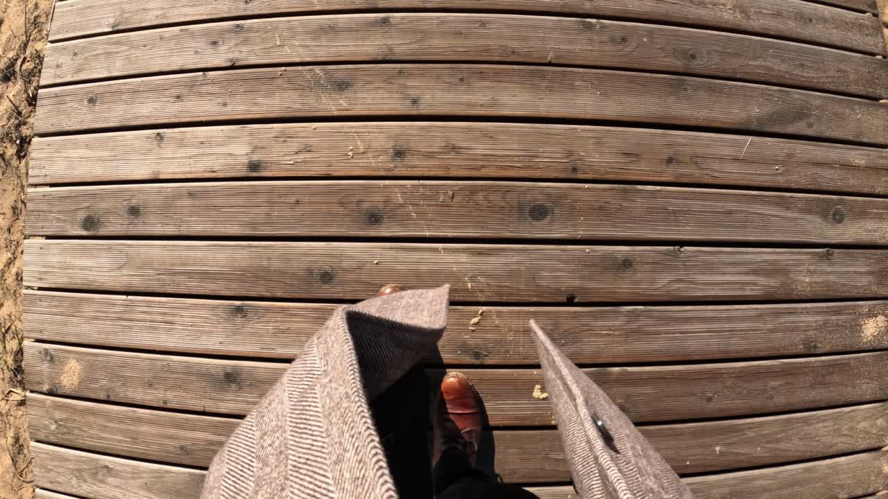 POV Walk: Person Stepping on Wooden Boardwalk in Kipsala Riga Area