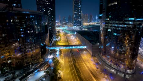 cars zooming along the streets of abu dhabi, united arab emirates on al reem island at night - motion time lapse