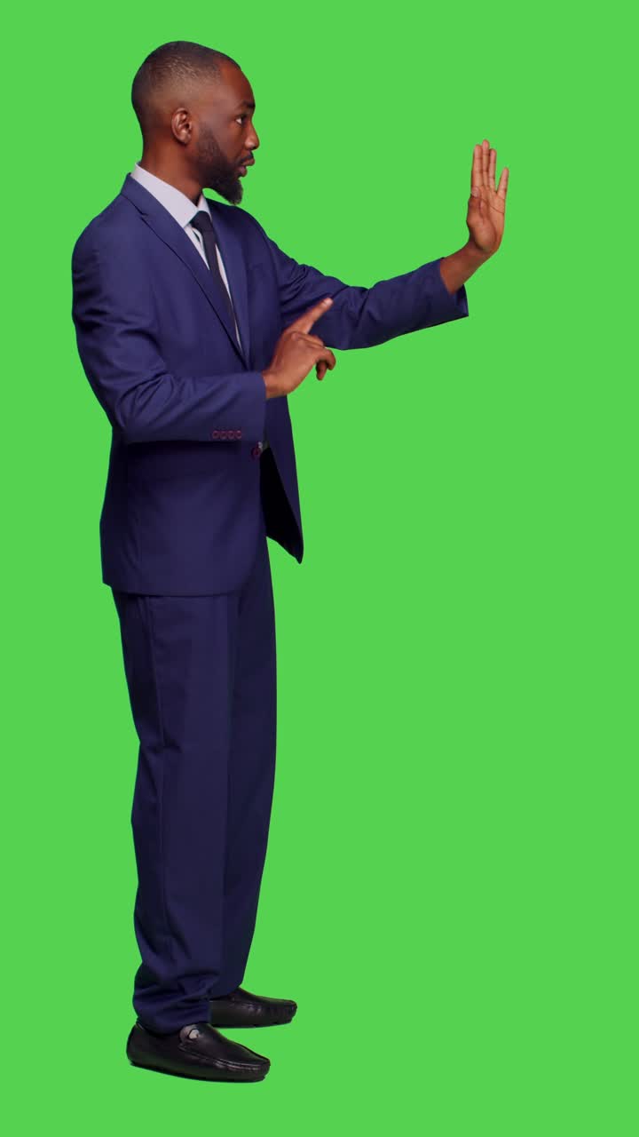 Vertical video: Profile of negative businessman doing stop sign with palm raised