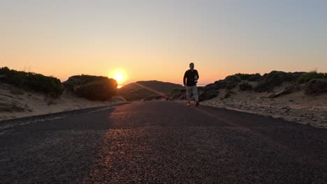 man walking on road during sunset in melbourne