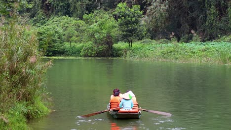 two people rowing a boat in nature