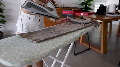 woman ironing pants