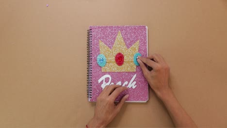 gluing paper art on custom made notebook cover, handmade paper crafts