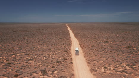 Aerial-view-of-a-van-and-a-trailer,-sunny-day-on-a-desert,-in-Australia---dolly,-drone-shot