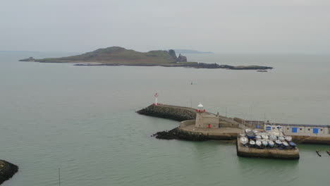 cinematic aerial dolly framing howth lighthouse and ireland's eye island