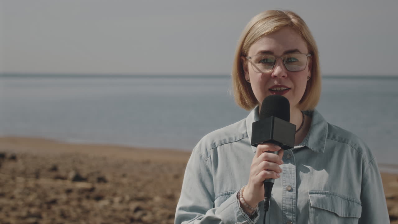 Female TV Reporter Talking in Mic at Gulf Coast