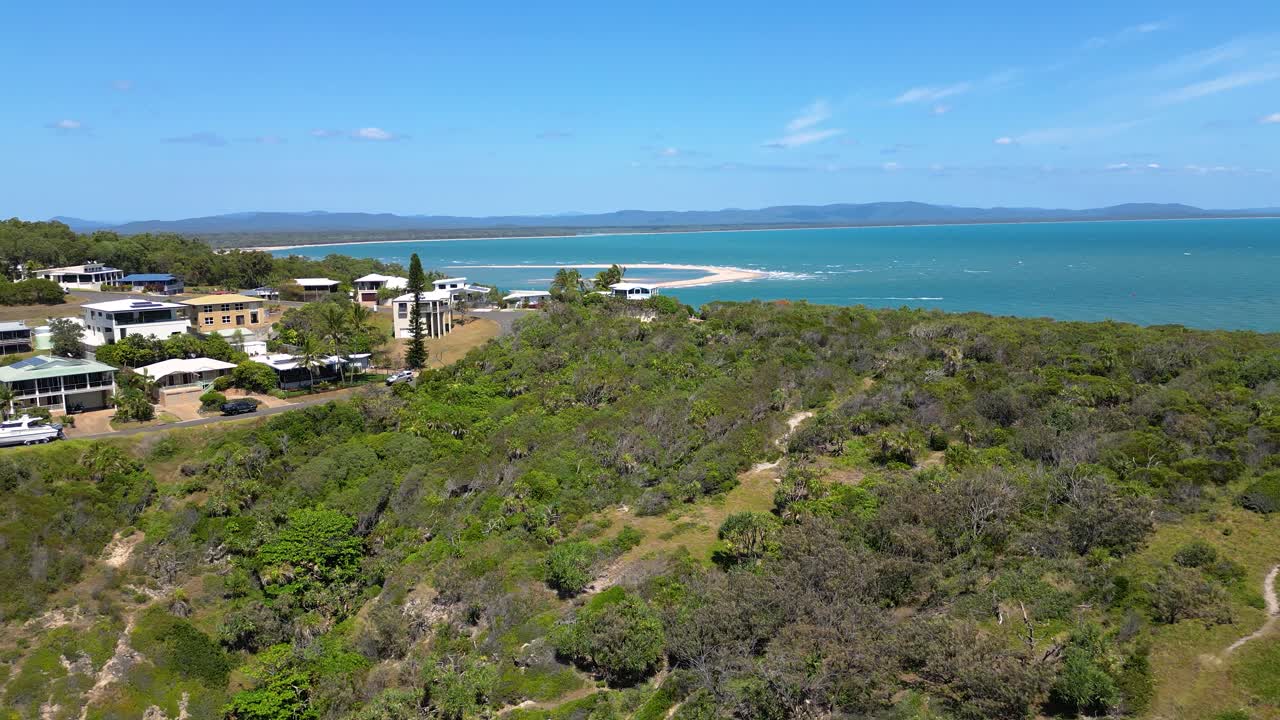 Right to left aerial views over residential housing at the Town of 1770, Central Queensland, Australia