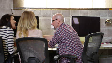 designers working at desks in modern office shot on r3d