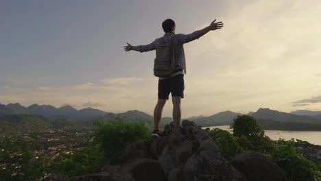 man enjoying a view from a mountaintop