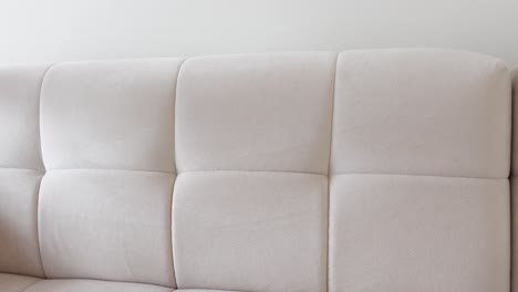 a woman is vacuuming a couch in a living room