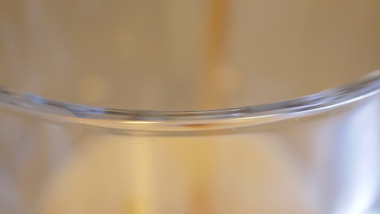 큰 유리잔의 입술은 어두운 탄산 다이어트 소다가 꼭대기에 여있는 것처럼 초점을 맞추고 있습니다.