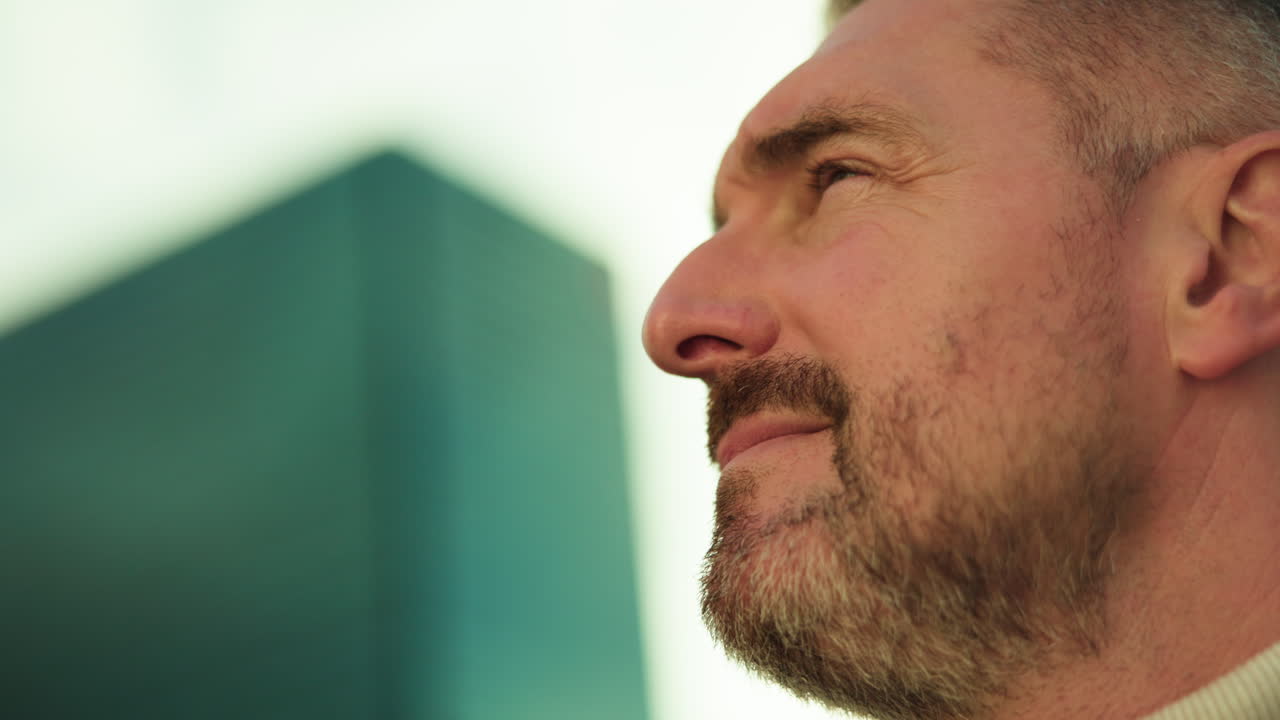 Close-up portrait of a mature man with beard looking up