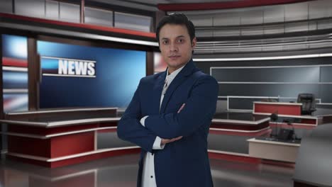 Portrait-of-confident-Indian-journalist-standing-crossed-hands