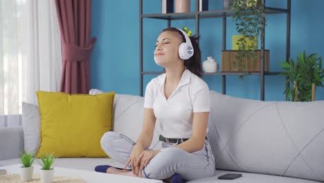 happy young woman listening to music with headphones.