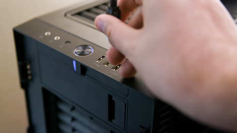 man unplugs multiple usb cables from desktop computer