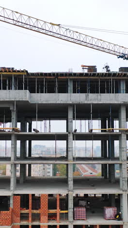 Construction of a residential apartment complex. Aerial view. Vertical video