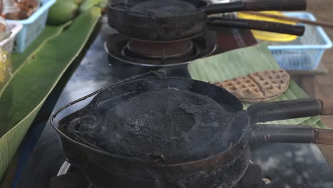 street food vendor is preparing thai style waffle a kind of ancient thai dessert-snack, made of rice flour, coconut milk, etc