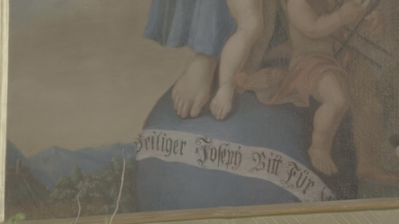 "성 요셉이 우리를 위해 간구합니다"라는 배너가 있는 그림 클로즈업