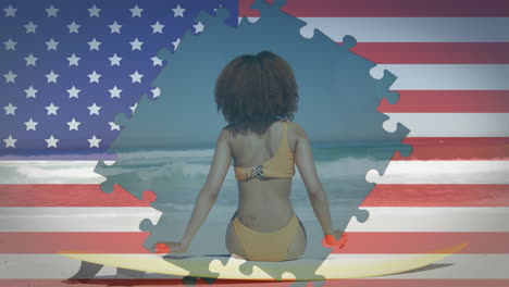 animation of flag of usa over african american woman with surfboard on beach