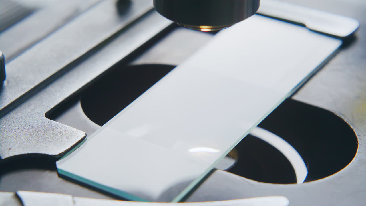 Dropping Yellow Liquid onto Slide for Scientific Observation in Lab