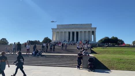 people relax on the steps of the lincoln memorial in washington dc