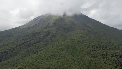 aerial climbs cone mountain slope of arenal volcano, costa rica jungle