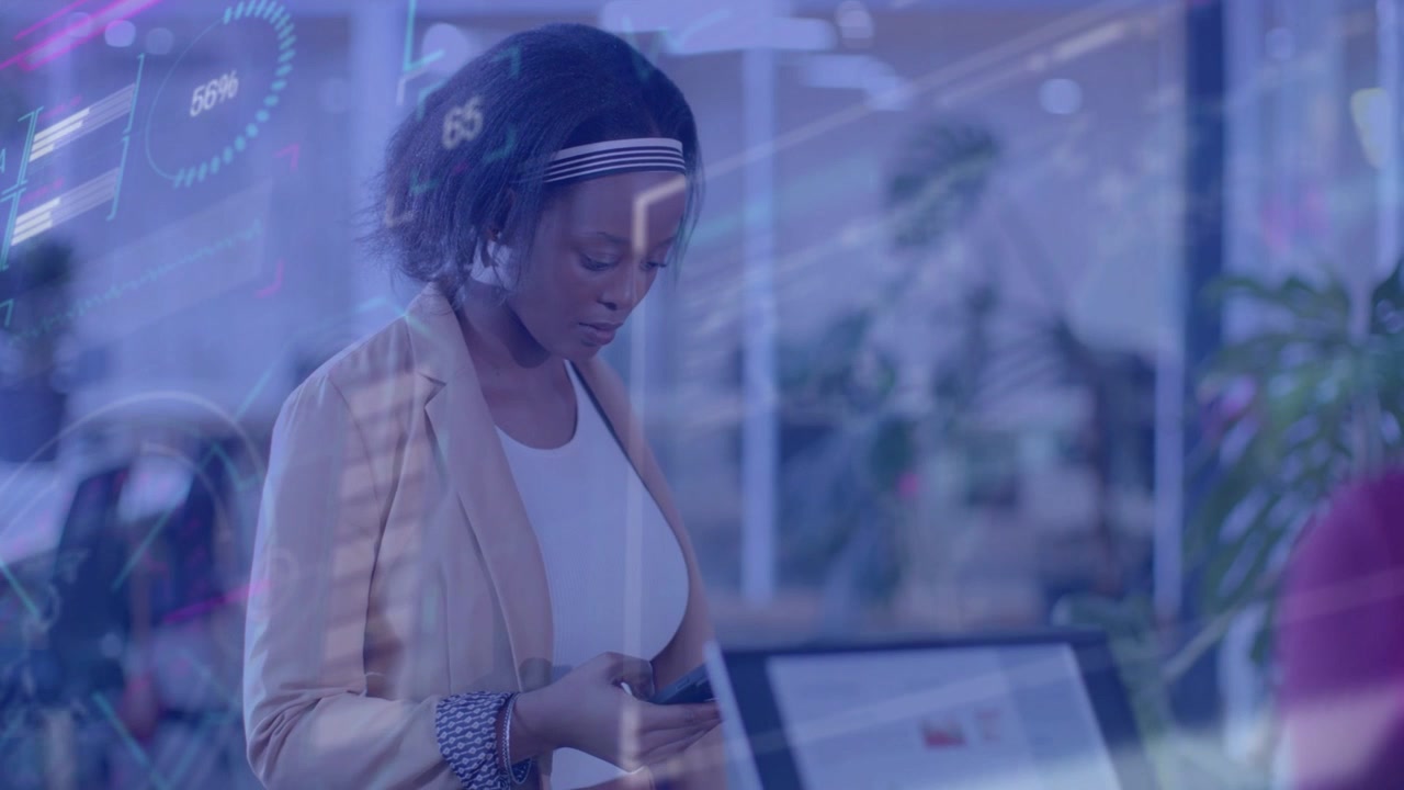 Woman at desk tapping phone, scrolling and checking metrics on laptop as tech gauges overlaying