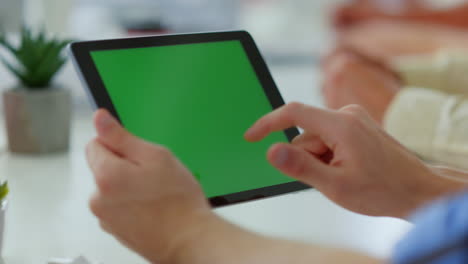 Male-finger-touching-tablet-green-screen.-Unknown-man-using-digital-device.