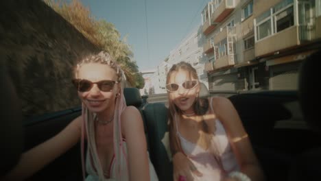 Two women enjoying a sunny day in a convertible