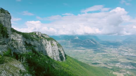 go along rock's wall and cliff with high altitude view on valley, french alps