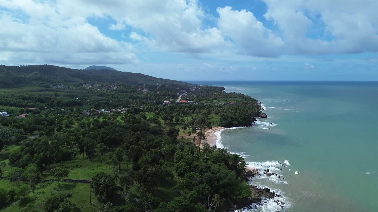 Low altitude drone footage gliding over Koh Lanta beach with turquoise water, golden sand and vast open sea horizon, highlighting tropical island beauty in southern Thailand