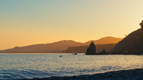 Colourful-sunset-at-Playa-de-las-Alberquillas,-Spain