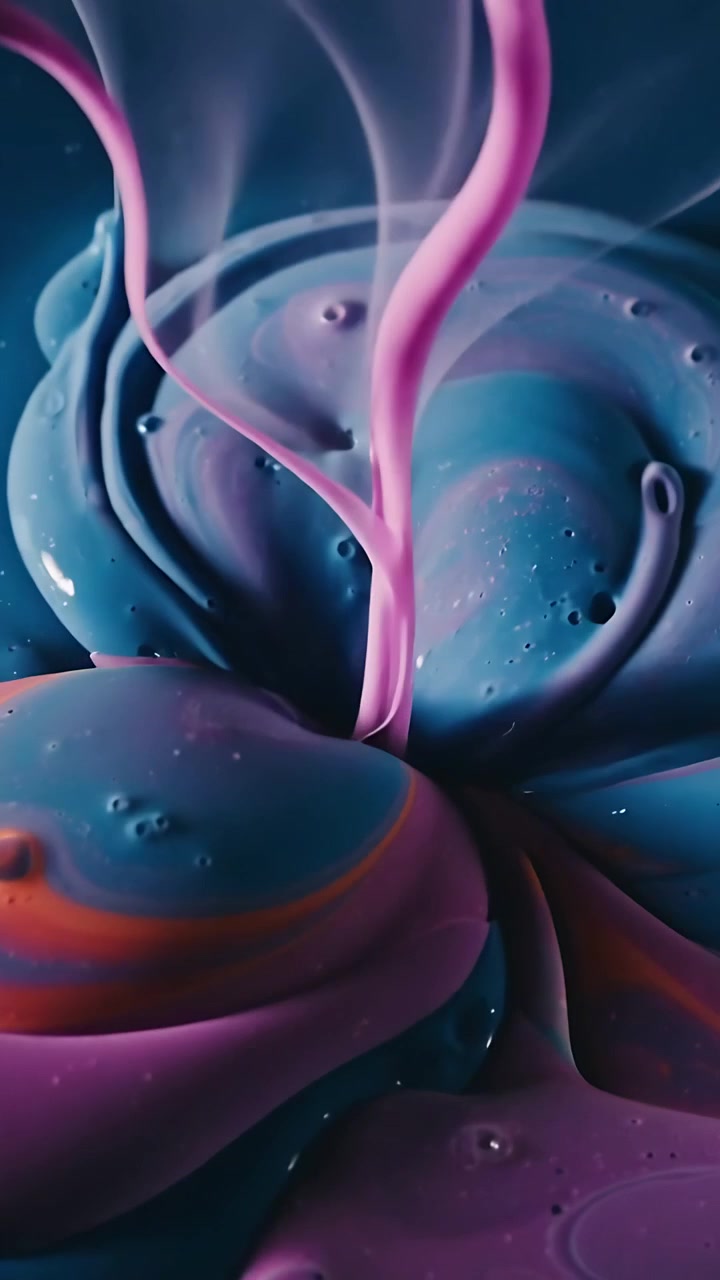 Vertical video: Pouring pink ribbons touching teal purple blobs on navy tray blending into marble