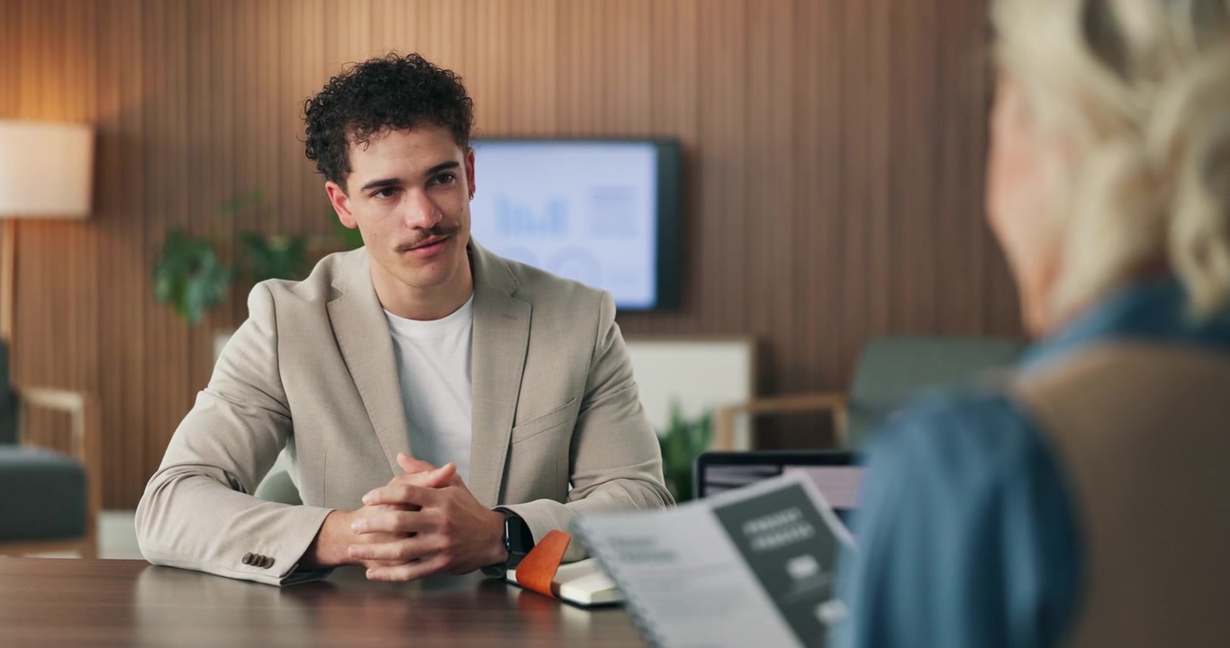 Young Professional Man Handing Document to Colleague in Office Meeting