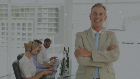 white particles floating against portrait of caucasian senior businessman smiling at office