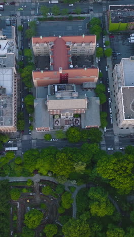big beautiful green park neighboring residential area. new york at daytime. bird's eye perspective. vertical video