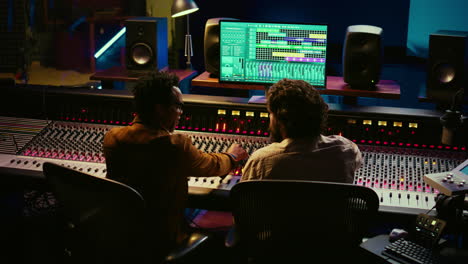 musician and audio engineer sharing high five after creating beautiful hit song