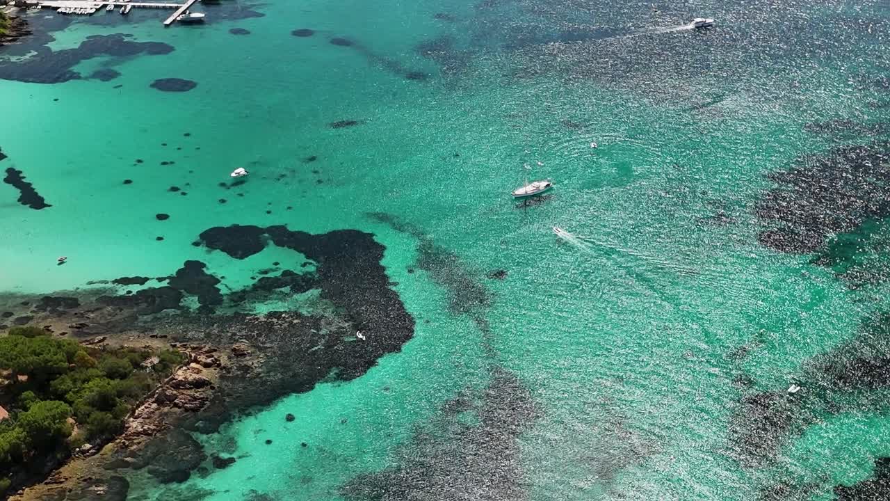 Exploring the clear waters and boats in Sardinia's coastal area